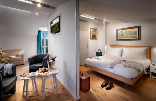 a bedroom with a bed and a chair and a table at Centro Storico in Neviglie