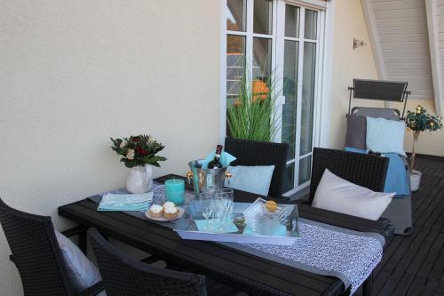 a table with a tray of food on a patio at Ferienwohnung am Rosengarten in Ebermannstadt