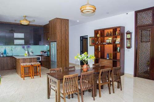 cocina y comedor con mesa y sillas en Bella House, en Hue
