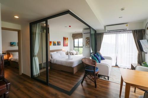 a hotel room with a bed and a dining room at La Habana Hua Hin 2 Bedroom Seaview in Hua Hin