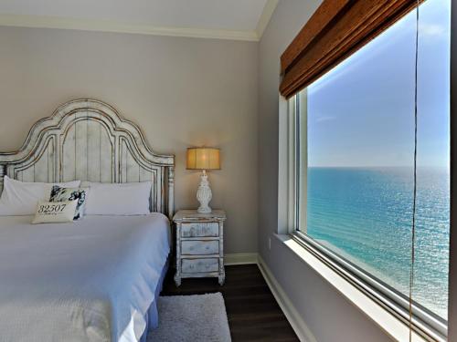 a bedroom with a bed and a large window at Indigo West #2004 in Perdido Key