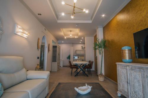 a living room with a couch and a table at Apartamentos Turísticos La Baílla in Rota