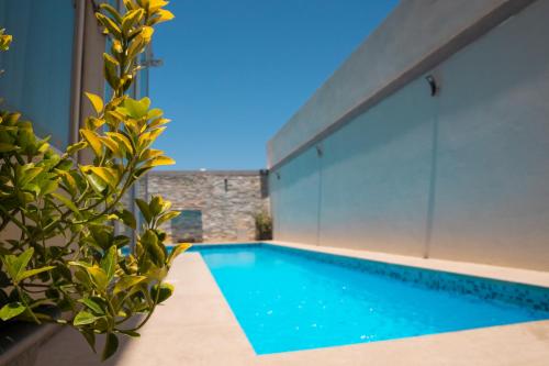 a swimming pool in the middle of a house at St. Peter's Pool Holiday Apartment in Marsaxlokk