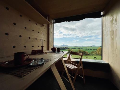 a room with a table and chairs and a large window at Krabička K74 in Jablonné v Podještědí