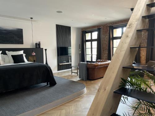 a bedroom with a bed and a living room at Ennéa - Jacuzzi & Luxury Suites in Perpignan