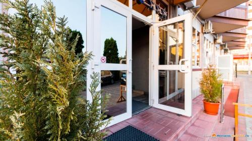 a sliding glass door on a building with plants at Anomis in Cîmpulung