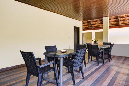 a dining room with a table and chairs at Coorg Bliss Estate Stay in Madikeri