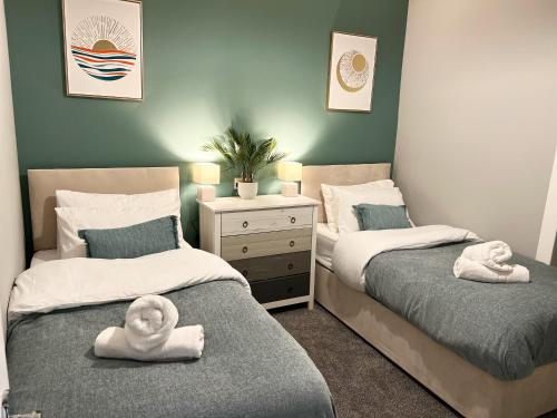 Duas camas com toalhas num quarto em belmont street em Hull