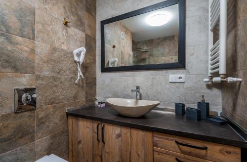a bathroom with a sink and a mirror at New Gudauri Atrium apartment #233 in Gudauri