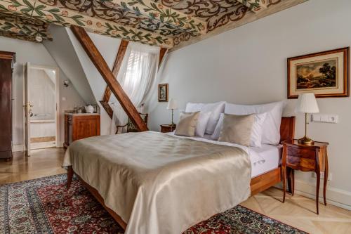 a bedroom with a king sized bed in a attic at Hotel Nerudova 211 in Prague
