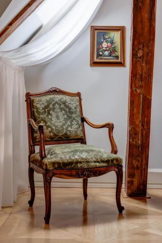 a chair sitting in a room next to a wall at Hotel Nerudova 211 in Prague
