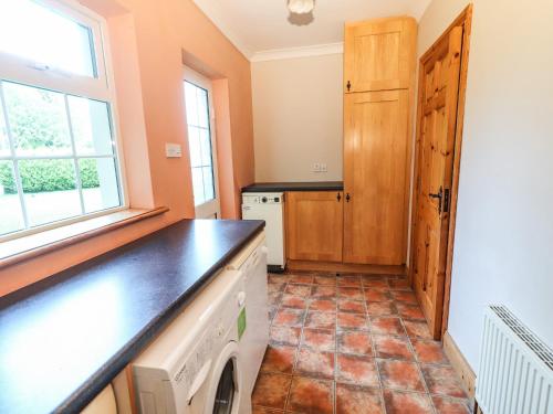 a laundry room with a washer and dryer at Fernwood in Killarney