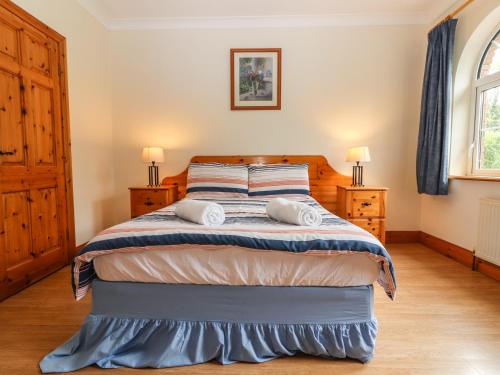 a bedroom with a bed with two towels at Fernwood in Killarney