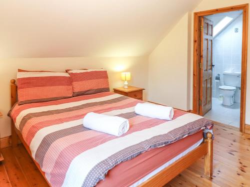 a bedroom with a bed with two pillows on it at Fernwood in Killarney