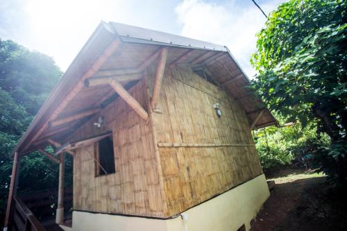 a building that is made out of wood at Shuit Bambou in La Trinité