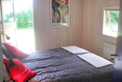 a bedroom with a bed with two towels on it at Sommerhus i Marielyst med Spa og Sauna, incl el og vand, tæt på by og strand in Marielyst
