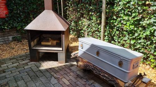 a woodburning stove and a stove with a box at AirstreamNB in Schayk