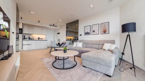 a living room with a couch and a table at Pinea, Sun & Snow in Pobierowo