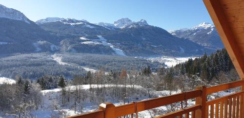 a view of a snowy mountain valley from a porch at nawu apartments & Restaurant in Hermagor