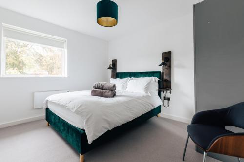a bedroom with a large bed and a window at Charlecote House in Bath