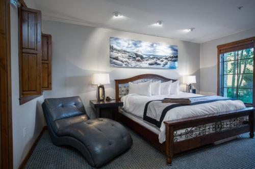 a bedroom with a large bed and a chair at 1 Bedroom Condo with Spa - Silver Baron Lodge condo in Park City