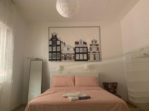 a bedroom with a bed with a painting on the wall at Adults only Beachhouse Pineto zona Corfu in Pineto