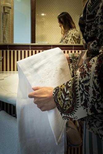 a person is holding a piece of paper at Hotel Petite Fleur in Roccaraso