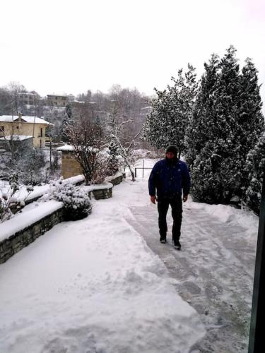 a man walking down a snow covered path at Sweet Home in Neraïdochóri