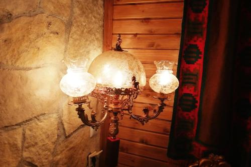 a couple of lights hanging on a wall at Sweet Home in Neraïdochóri