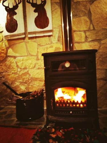 a fireplace with a fire in it in a room at Sweet Home in Neraïdochóri