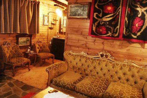 a living room with a couch and chairs in it at Sweet Home in Neraïdochóri