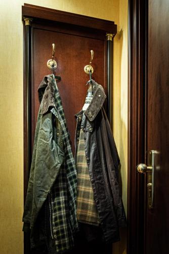 a pair of jackets hanging on a door at Hotel Petite Fleur in Roccaraso