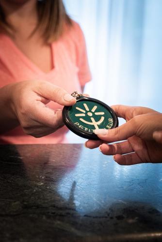 a woman is holding a clock in her hands at Hotel Petite Fleur in Roccaraso