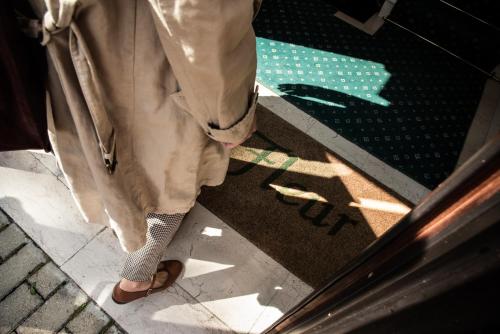 a person standing in front of a glass door at Hotel Petite Fleur in Roccaraso