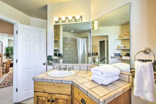 a bathroom with a sink and a large mirror at Cozy Eden Condo Retreat Less Than 6 Mi to Ski Resort! in Eden