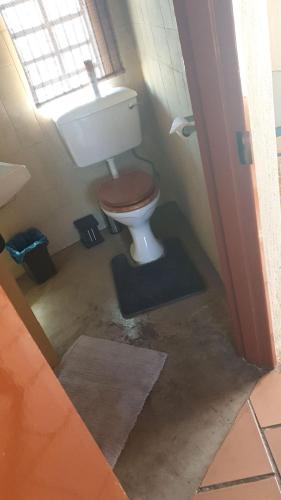 a bathroom with a toilet and a window at Kruger Ranch in Magaliesburg