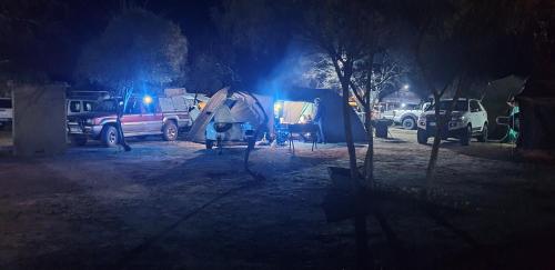 a group of tents in a parking lot at night at Kruger Ranch in Magaliesburg