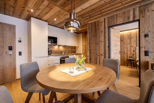 a dining room with a wooden table and chairs at Ferienanlage Central in Flachau