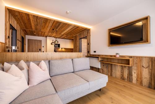 a living room with a couch and a flat screen tv at Ferienanlage Central in Flachau