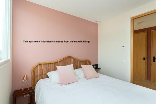 a bedroom with a bed with a sign on the wall at La Paulowna Boutique Hotel in The Hague