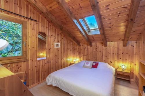 a bedroom with a bed in a wooden cabin at Chalet Mar'Mot in La Tzoumaz