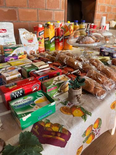 a table with food and other foods on it at B&B Bouganville in Rilievo