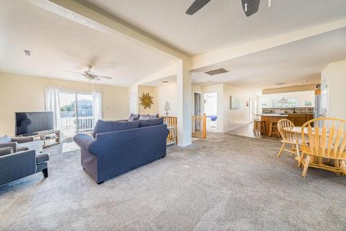 a living room with a couch and a tv and a table at Follow the Sun in Duck