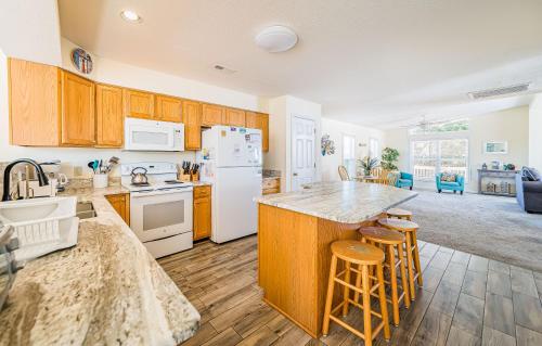 a kitchen with wooden cabinets and white appliances at Follow the Sun in Duck