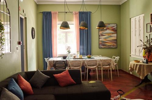 a living room with a couch and a dining room table at Eco Ljmonade Hostel in Cascais