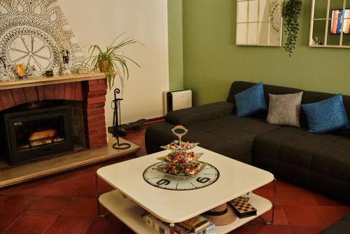 a living room with a couch and a fireplace at Eco Ljmonade Hostel in Cascais