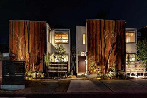 a building with curtains on the side of it at night at Rakuten STAY HOUSE x WILL STYLE Hachimanbori in Omihachiman
