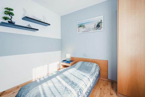 a bedroom with a bed and two pictures on the wall at Stral-Sund in Stralsund