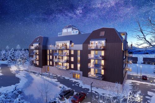 奧勒的住宿－Åre Travel - View，夜间在雪中 ⁇ 染建筑物