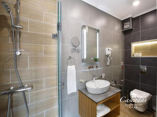 a bathroom with a sink and a shower at Cascadas Family Resort in Sunny Beach